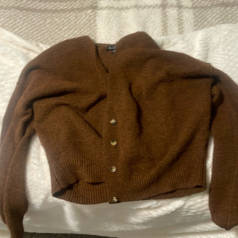 this is a brown button cropped sweater